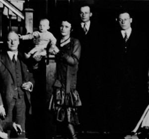 Forty-five years after the founding of the Club, first President Thomas Burgess stands at left for a family portrait in Colonel Alexander B. Crane’s entrance hall.
 