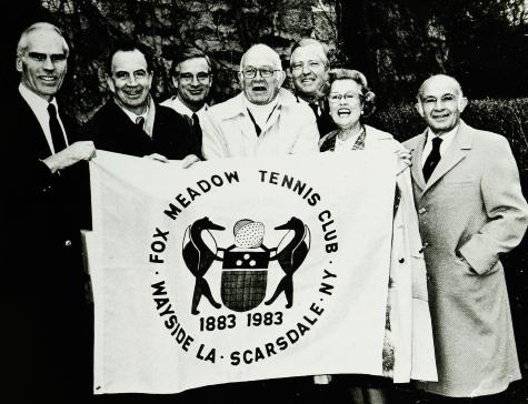 The FMTC Centennial Committee - Ware, Close, Evans, Harrison, Adams, Fuller and Balzac - proudly display Fox Meadow's new flag, made by Betty Rule