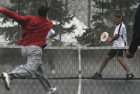Brian Uihlein hits a forehand drive during a snowy match at the 2008 Nationals in Rochester. Mike Cochrane is at net.