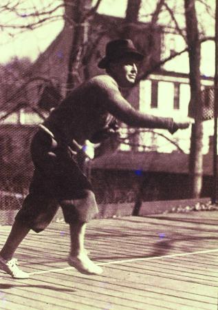 Just after serving, James K. Cogswell on the first platform paddle tennis court erected on his property