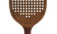 Early paddle with holes. The Old Army Athletes had worked with the Paddle Tennis Company to modify the standard paddle tennis paddle design to create a more rounded paddle with holes.