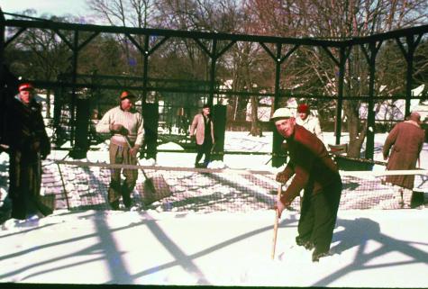 Charlie Johnson, foreground, inspires the snow shovelers with his own energy in the early years before under-court heaters