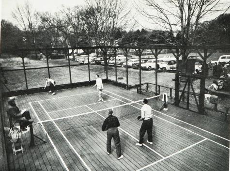 Rawle Deland takes one off the backstop while everyone else watches and waits
