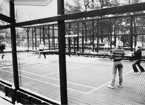 With snow still piled high on the bleachers, Dick Balza induces three friends to try a set or two.