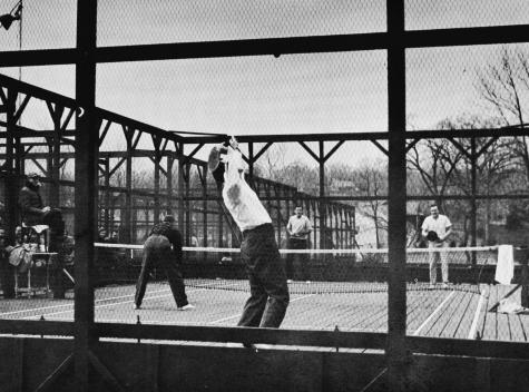 1955 Men's Nationals - Dick Hebard, serving, and partner Jim Carlisle play Rawle Deland and John Moses. Earle Gatchell is in the umpire’s chair.