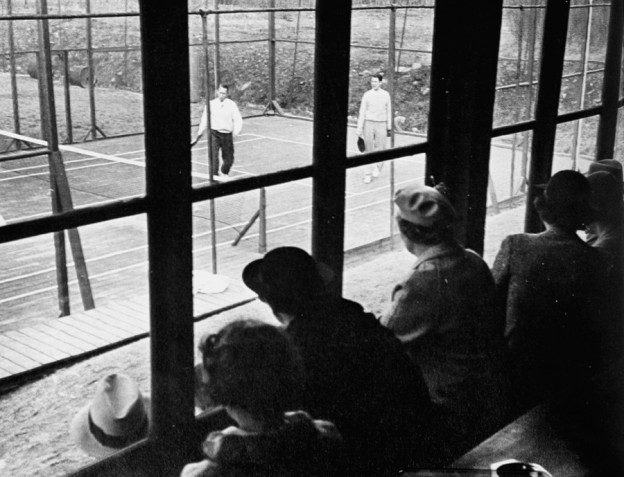"Let the Gallery have comfortable benches from which they can look down on the court". In the mid 1930s the porch was glassed in to make watching more pleasant.